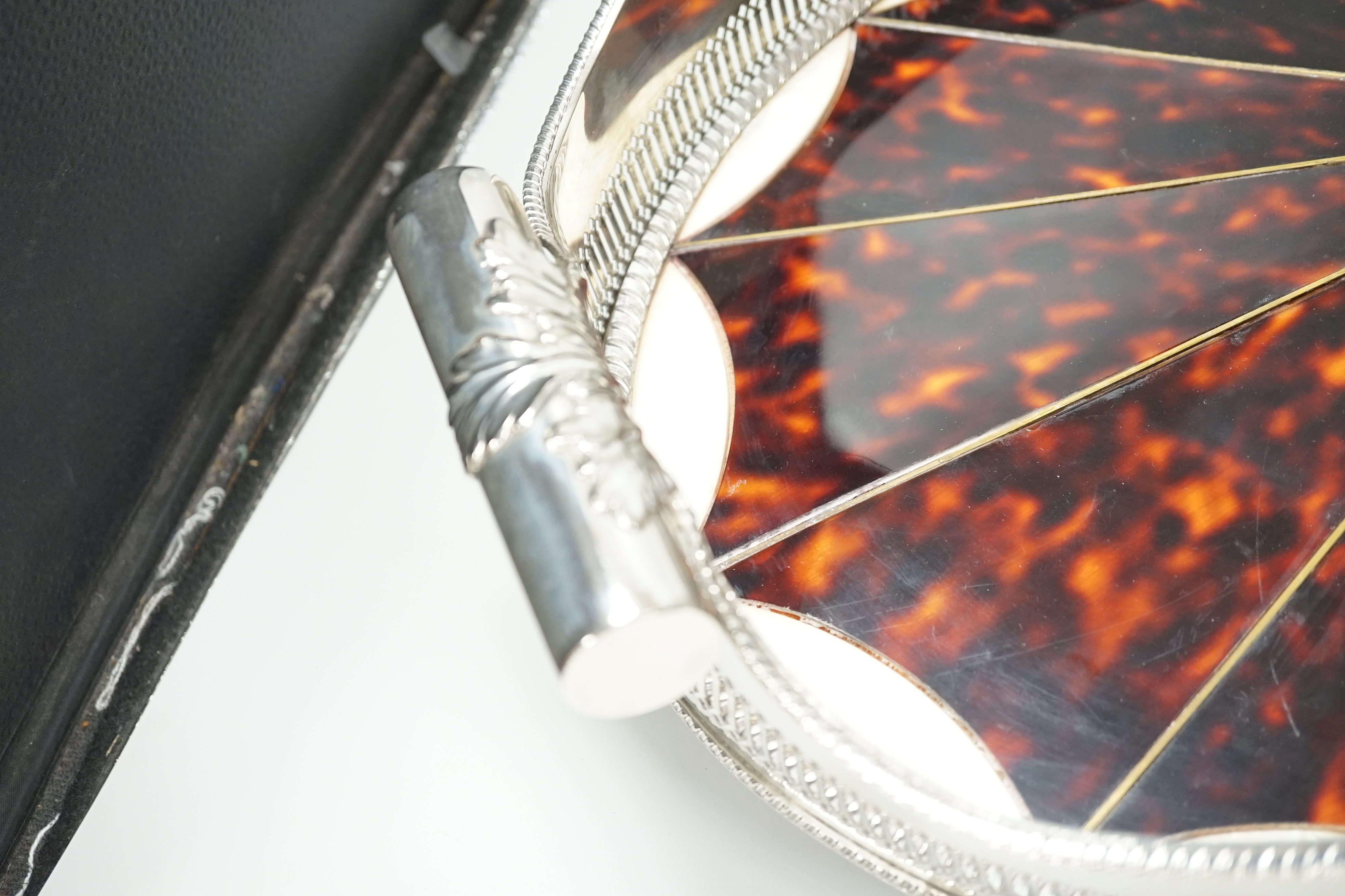 An unusual Adam style tortoiseshell and mother-of-pearl inlaid plated oval with ‘paterae’ decoration, 65cm wide